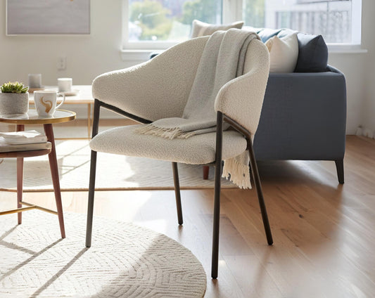 Modern living room with a gray sofa, beige armchair, and wooden coffee table.