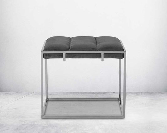 Ottoman upholstered in fabric with high polished stainless steel frame and legs front view