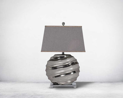 Silver table lamp in ceramic with metal base & translucent fabric shade.
