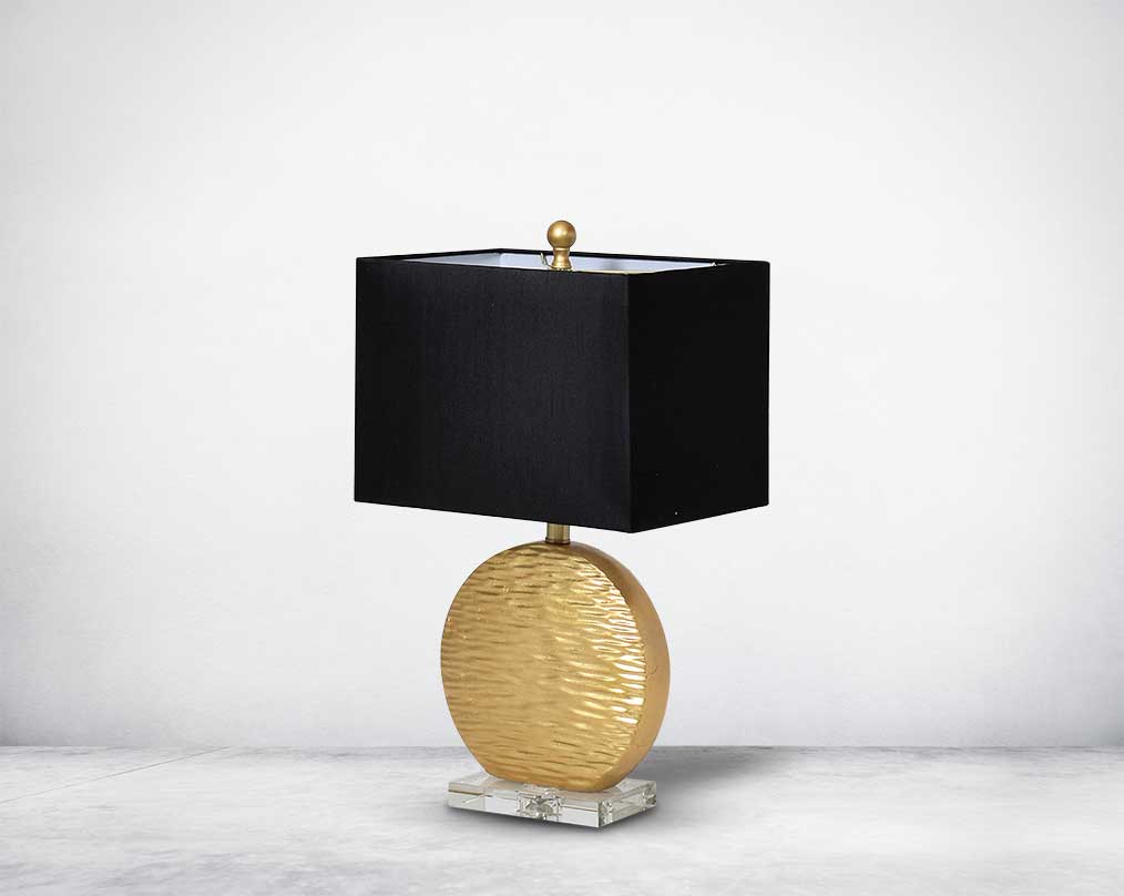 Table lamp in gold decorative glass base on a silver-plated metal stands with black fabric translucent fabric shade side view