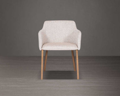 Beige armchair with wooden legs on a gray background