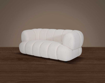 This sinuous & soft 2 seater sofa exudes a sense of calm & ease, upholstered in high-quality boucle fabric with wooden legs side view