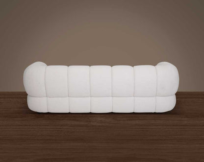 This sinuous & soft 3 seater sofa exudes a sense of calm & ease, upholstered in high-quality boucle fabric with wooden legs back view