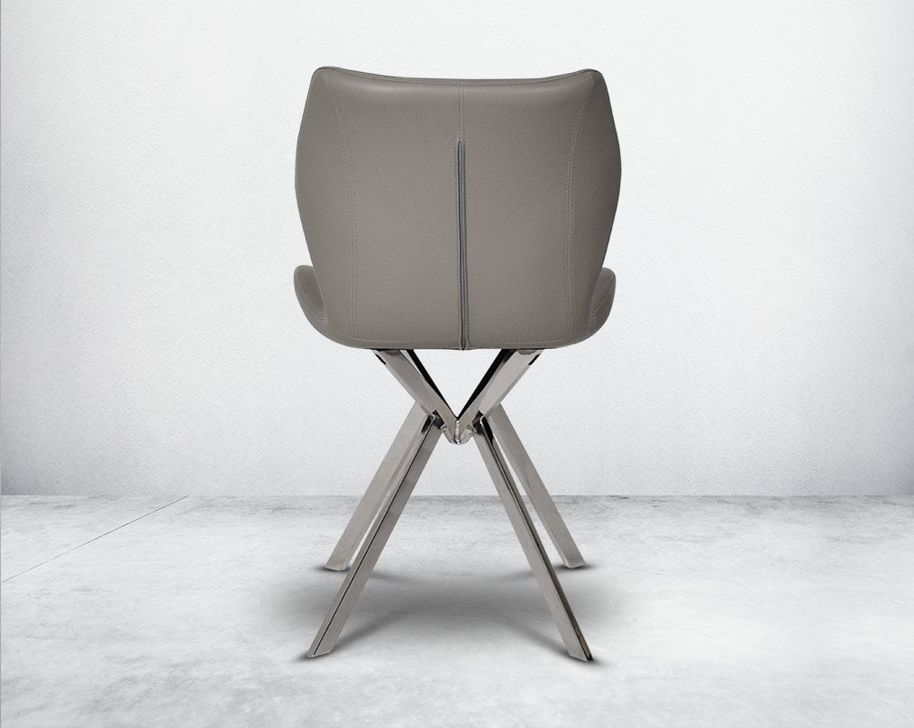 Dining chair upholstered in faux leather with stainless steel legs back view