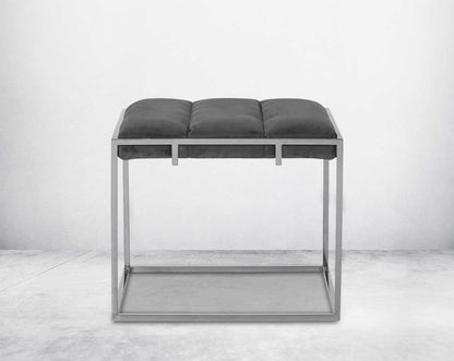 Ottoman upholstered in fabric with high polished stainless steel frame and legs front view