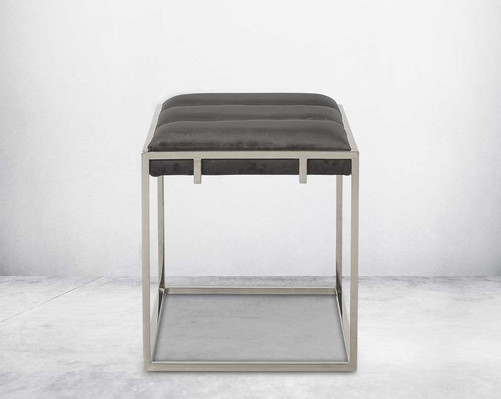 Ottoman upholstered in fabric with high polished stainless steel frame and legs.