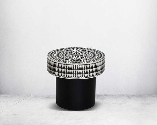 This gorgeous black and white inlay end table with a black metal base is a perfect statement piece in your living room.