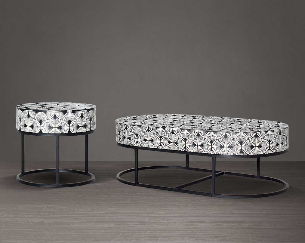 This gorgeous black and white inlay coffee and end table in floral pattern with a black metal base is a perfect statement piece in your living room.