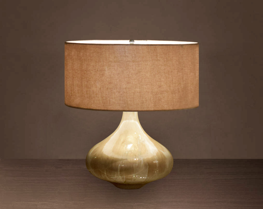 Glass table lamp in Enamel feel with a teardrop-shaped base and translucent beige fabric shade.