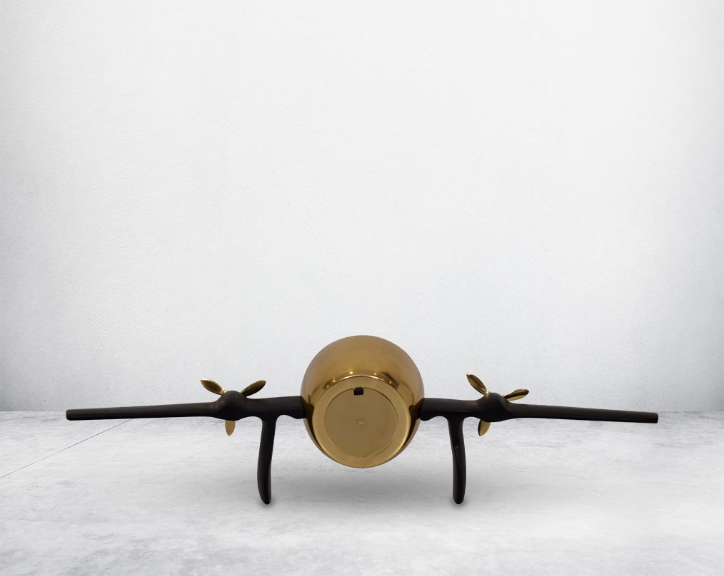 This unique vintage airplane propeller table clock comes with the clock in the back  of the wings. This antique clock is made out of brass in antique matt finish. It has a white dial with Roman Numerals for a vintage look. This is a great statement piece 