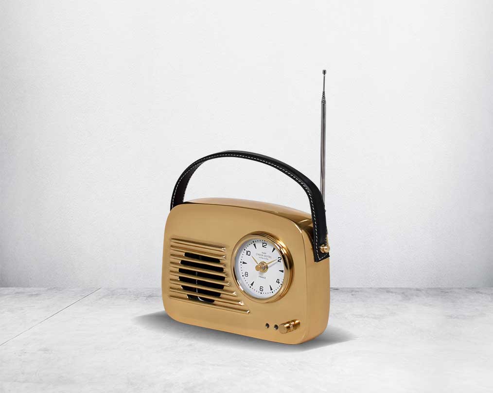 This unique retro table clock is sure to make a statement in any home. It is crafted in antique brass. Has a functional cock in vintage radio design. 