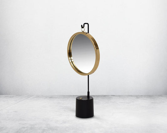 Round table dresser mirror suspended on a hook in shiny antique brass & matt black finished base. The look is very retro modern.