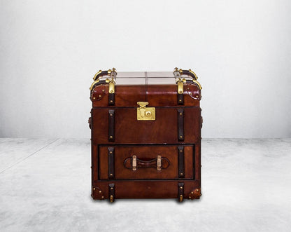 End table in distressed cognac leather in a vintage look with front view storage and 1 drawer in trunk design.