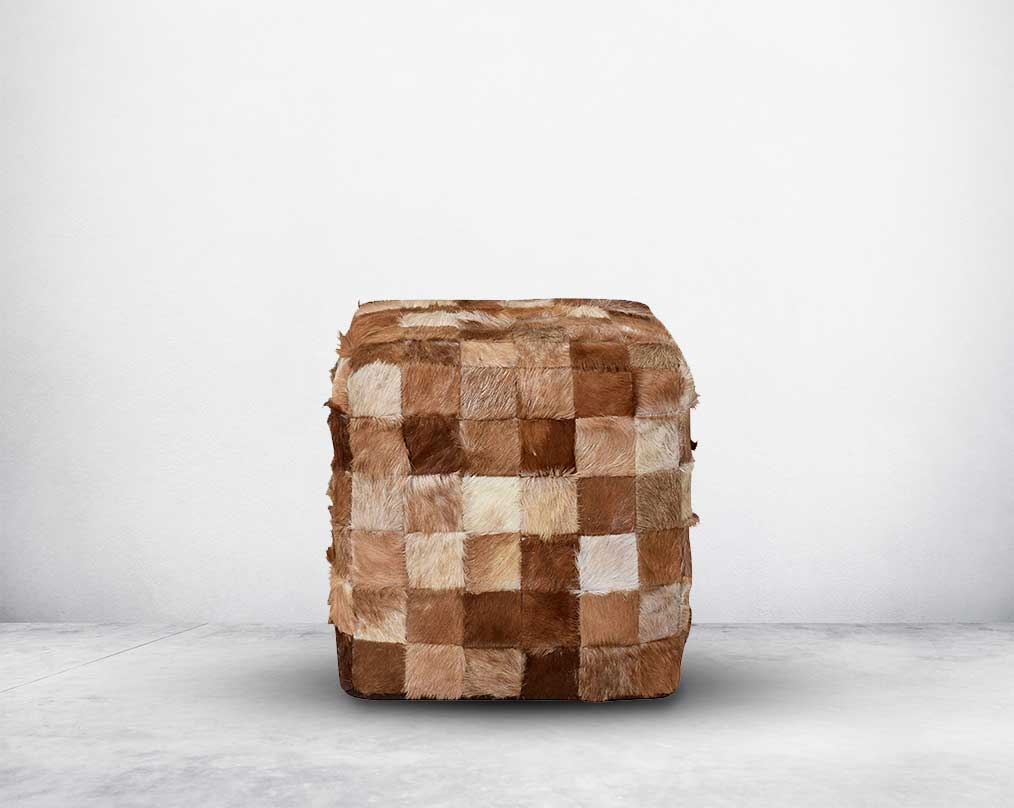This square-shaped brown pouffe is crafted from wood and wrapped in genuine hair-on cutout leather in diff shades of brown which gives a rich contemporary look to any modern space.