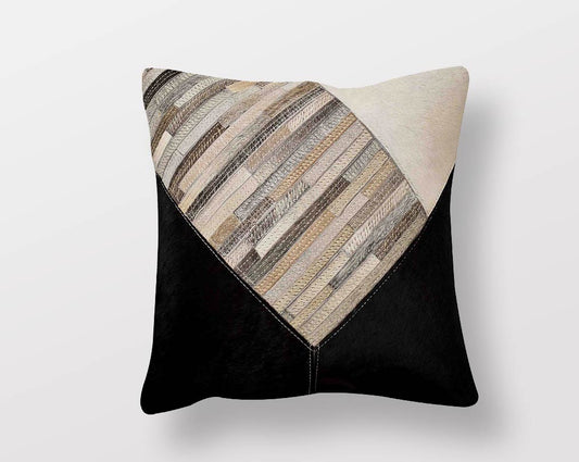 White, black & grey hair on & leather cushion.