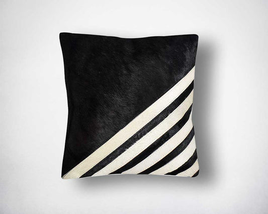 White, black & grey hair on a leather cushion.