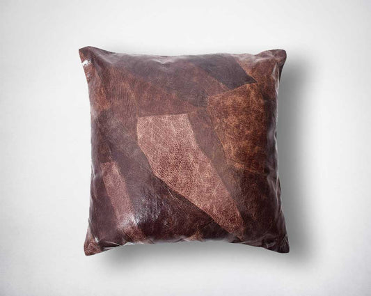 Patched suede leather cushion.