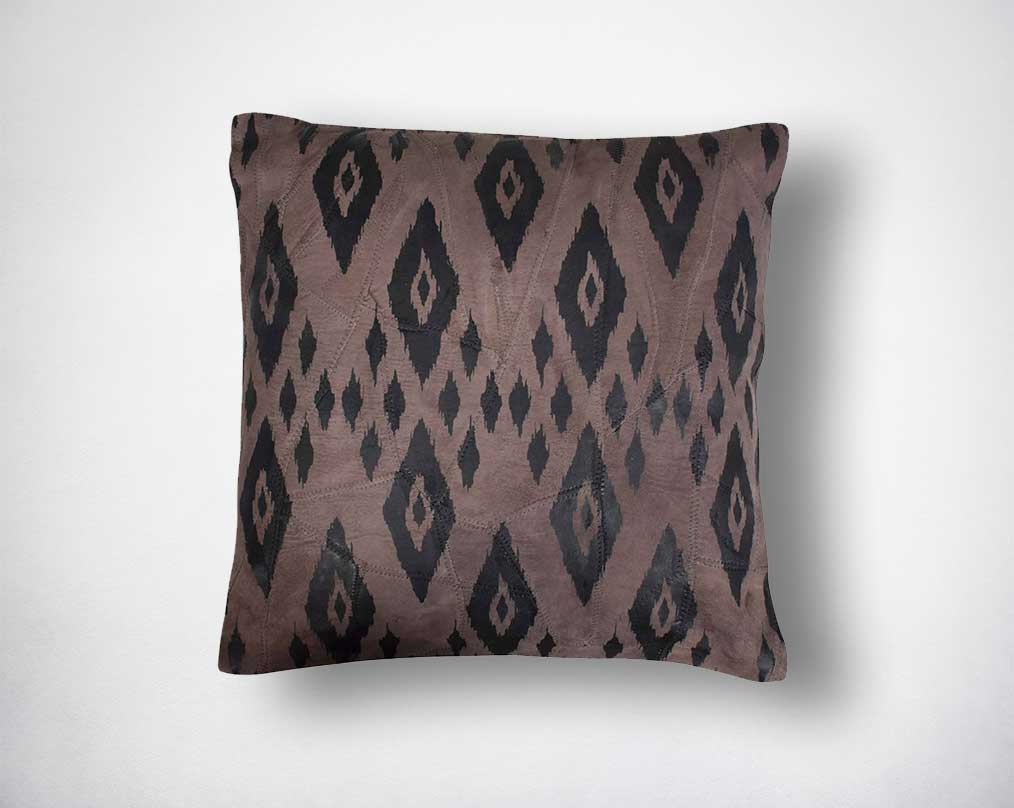 Leather cushion with eye print.