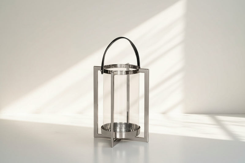 this lantern A master of reimagining classic forms, solid sheet metal frames feature broad panels of clear glass in a circular design large 
