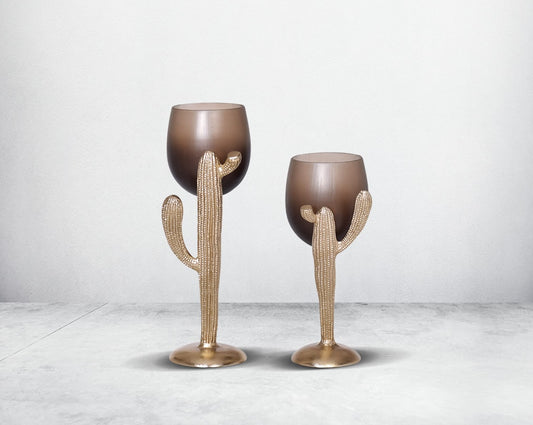 The pillar holder cactus design motif is crafted with green lustre glass with an antique gold finish aluminium decorative base.