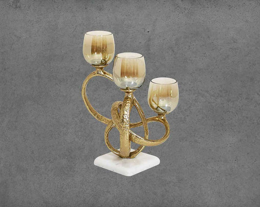 Multi T-light candle holder in gold-finished nickel plated aluminum, smoke luster glass with white marble base.