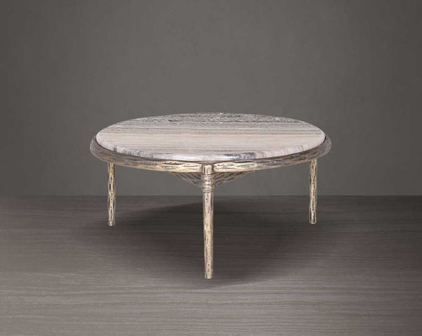 Round marble table with decorative legs on a dark background