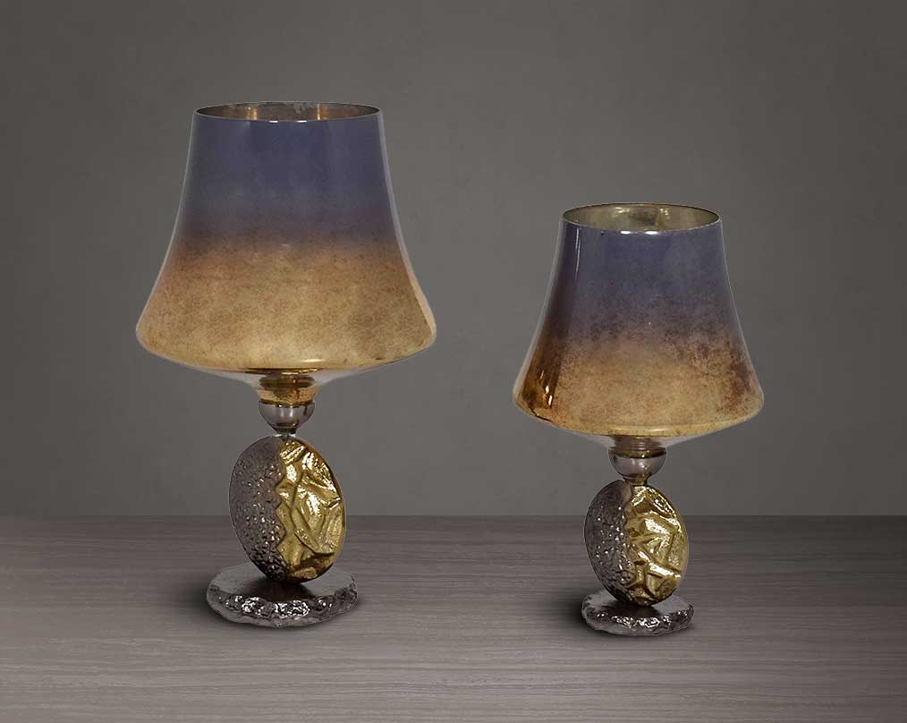 Candle holder in solstice champagne lustre glass and antique nickel-plated textured aluminum decorative base. 