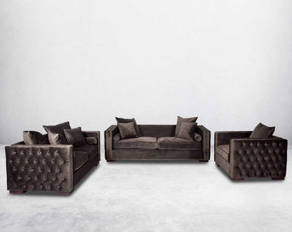 3+2+1 seater sofa set upholstered in fabric with gold rivets on the arms and front and tufted on the sides.