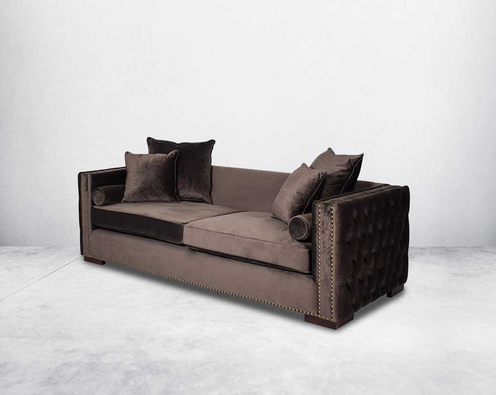3 seater sofa set upholstered in fabric with gold rivets on the arms and front and tufted on the sides side view