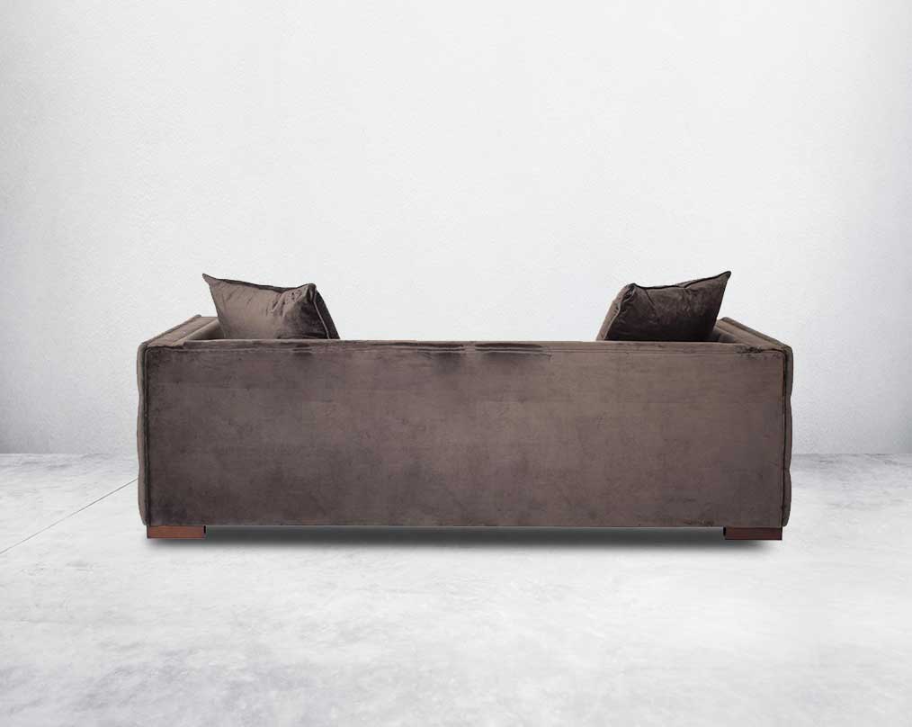 3 seater sofa set upholstered in fabric with gold rivets on the arms and front and tufted on the sides back view