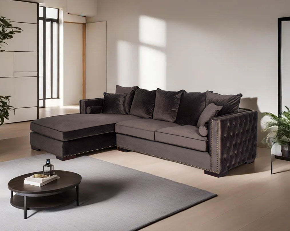 Left and right aligned sectional sofa with chaise, upholstered in fabric and tufted on the sides the sofa comes with cushions to match and has wooden legs.