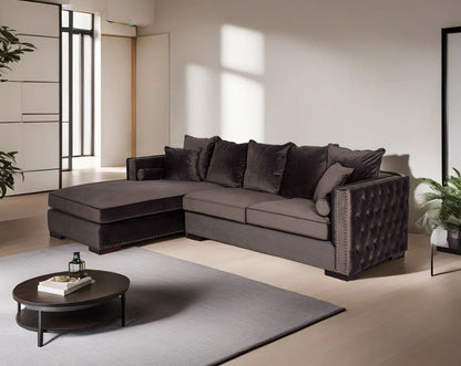 Left and right aligned sectional sofa with chaise, upholstered in fabric and tufted on the sides the sofa comes with cushions to match and has wooden legs.