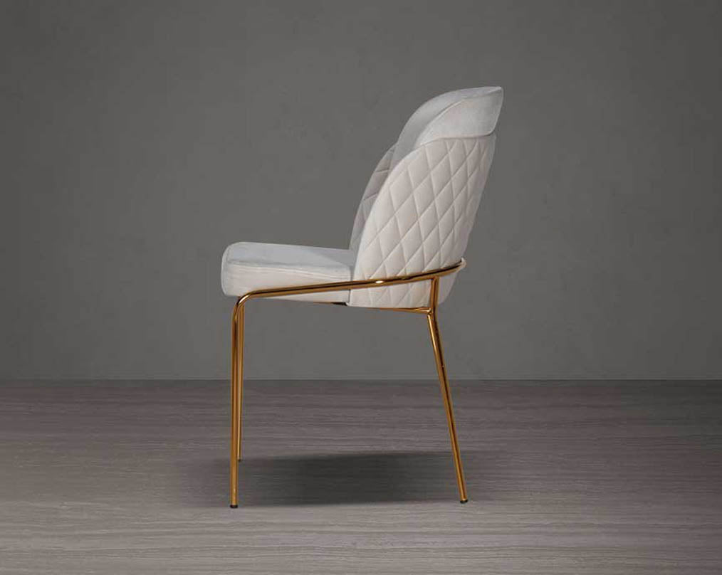 designed chair with side view  criss-cross stitch padded fabric in gold finish stainless steel legs in contemporary design.