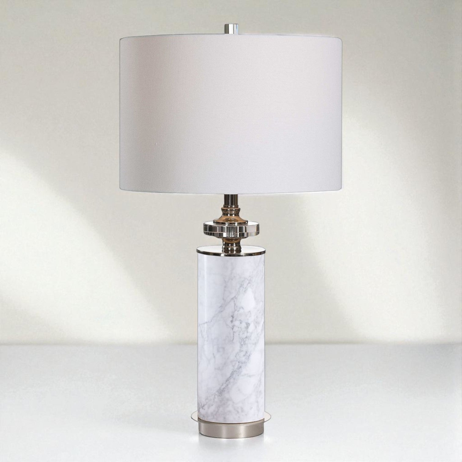 Table lamp with marble base and white shade on a light background