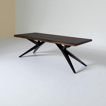 Wooden dining table with black metal legs on a white background