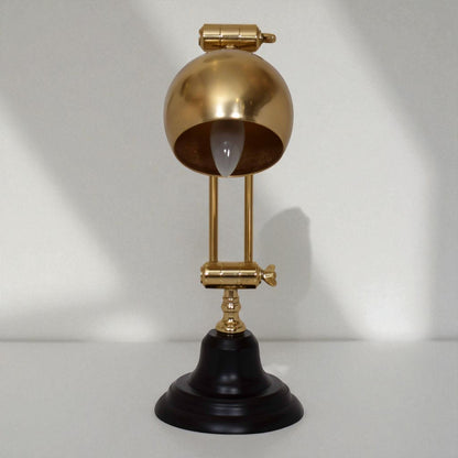 Decorative lamp with gold and black design on a white background