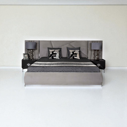 Modern bedroom setup with a bed, nightstands, and lamps against a white wall.