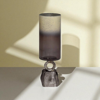 Decorative table lamp with a textured shade and metallic base on a neutral background