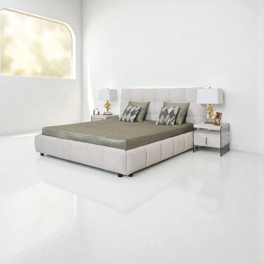 Modern bedroom with a gray upholstered bed, nightstands, and lamps.