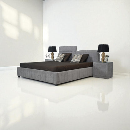 Modern bedroom setup with a gray bed, nightstands, and lamps in a minimalistic room.