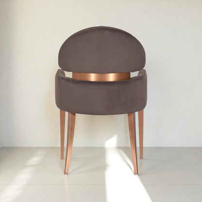 Chair with brown cushioned backrest and bronze legs on a white background