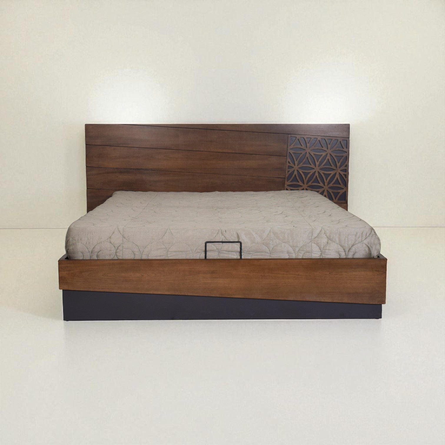 Wooden bed with a patterned headboard and light mattress, shown from the front in a minimal white room.