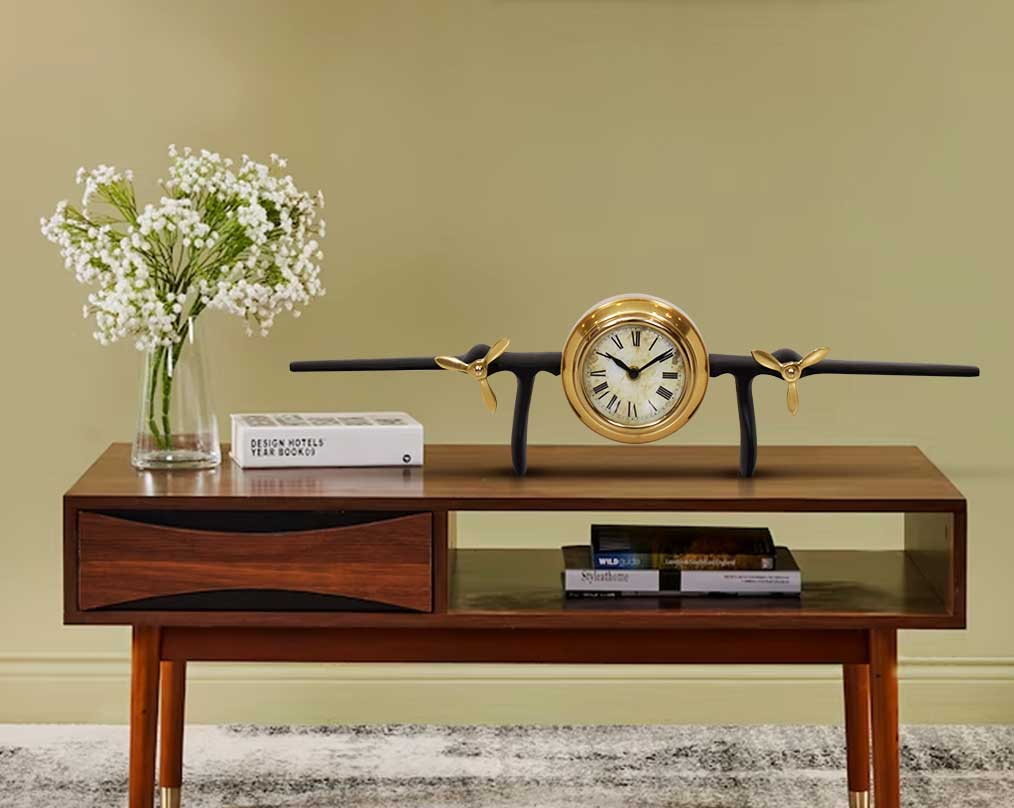 This unique vintage airplane propeller table clock comes with table and book the clock in the center of the wings. This antique clock is made out of brass in antique matt finish. It has a white dial with Roman Numerals for a vintage look. This is a great 
