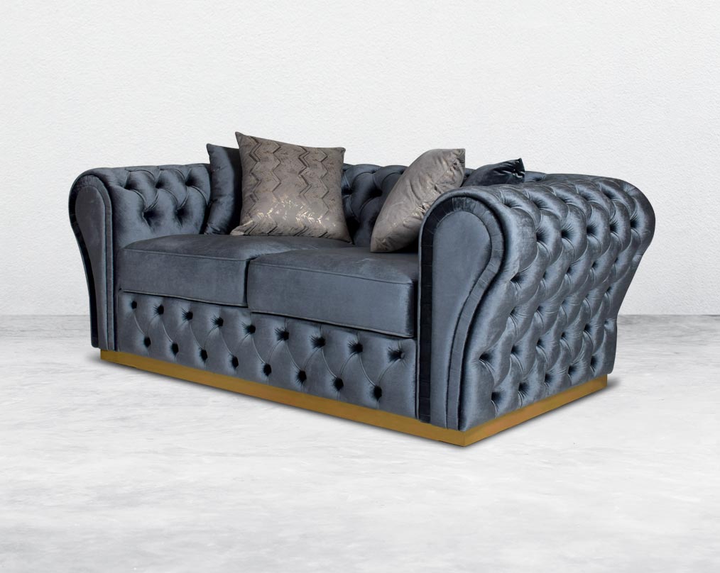 This 2 seater sofa set has a resplendent accentuated designer look and elegantly flared plush tufted armrests and backrest for an opulent style. The sofa is upholstered with high-quality velvet fabric and comes with 4bbeautiful cushions to compliment