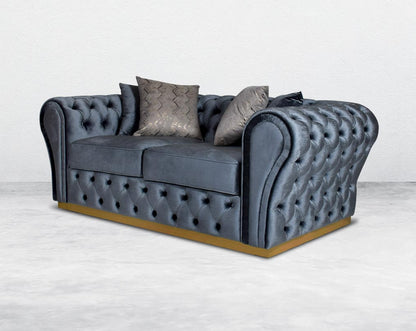 This 2 seater sofa set has a resplendent accentuated designer look and elegantly flared plush tufted armrests and backrest for an opulent style. The sofa is upholstered with high-quality velvet fabric and comes with 4bbeautiful cushions to compliment