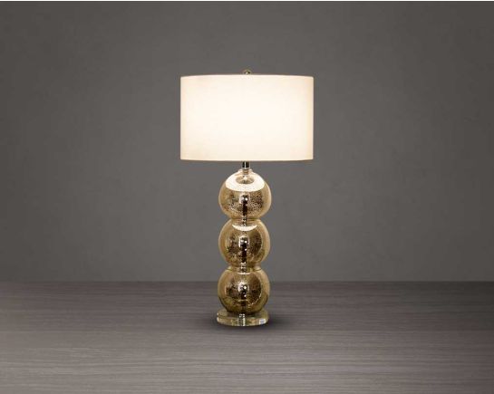 Table lamp with tinted crystal orbs on a silver-plated metal base with gold translucent fabric shade.