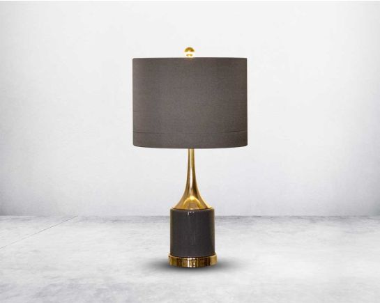 Table lamp in grey and gold metal base with translucent fabric shade in ultra-modern design.