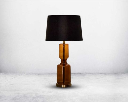 Table lamp with metallic gold and glass decorative base with translucent fabric shade.