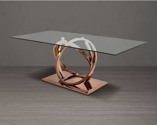 8 seater rectangular dining table with clear tempered glass top and artful stainless steel base plated in rose gold.