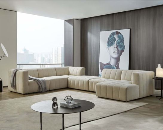 The L shaped modular sofa comes upholstered in regal beige fabric with vertical channel quilting & an ottoman to compliment with living room.